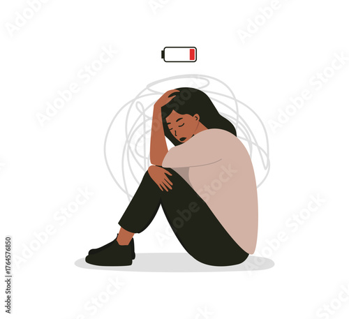A sad woman sitting with her knees drawn up and holding her head. Behind her are chaotic lines symbolizing emotional turbulence, and above is a low battery icon. Burnout, stress, and social fatigue.