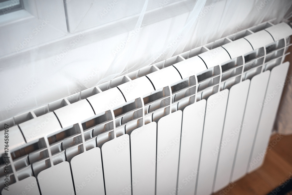 Obraz premium Heating radiator on a chilly winter day, energy and gas crisis, cold room, heating problems.
