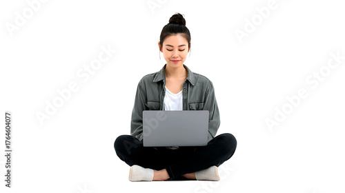 Asian girl sitting cross-legged using laptop, isolated on a white background