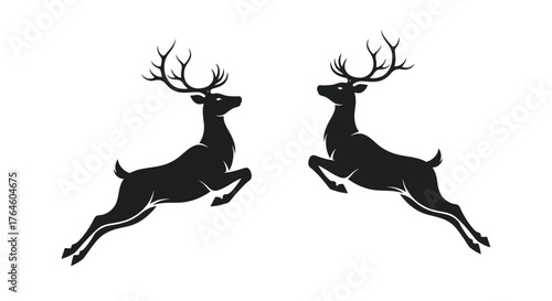 Two majestic black deer leaping gracefully against a white background, symbolizing freedom and nature's beauty
