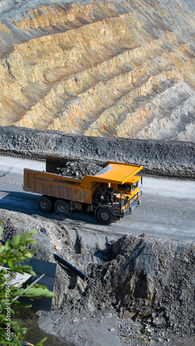 Obraz na plátně Rugged yellow mining truck crawls through geometric quarry, echoing Labor Days t