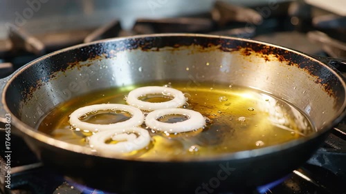 Onion Rings Frying in Hot Oil to Crispy Golden