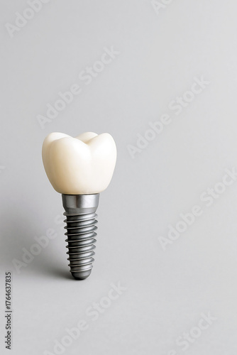 Dental implant is depicted on a plain gray background, demonstrating modern dental and restorative techniques. Ample space is provided for text.