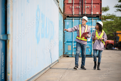 Engineer or worker is walking around inspecting the containers