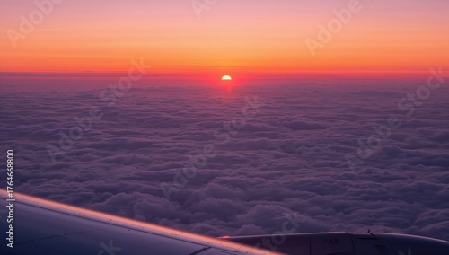 Fototapeta Naklejka Na Ścianę i Meble -  Sunset at night seen from an aircraft above the clouds