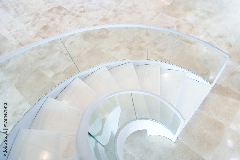 Fototapeta premium Beautiful white spiral staircase in the building