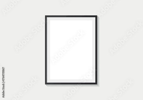 Framed print a blank rectangular whitecentered print in a thin black frame against a pale grey wall