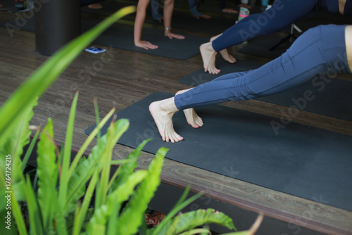 close up of legs and some women doing yoga movements