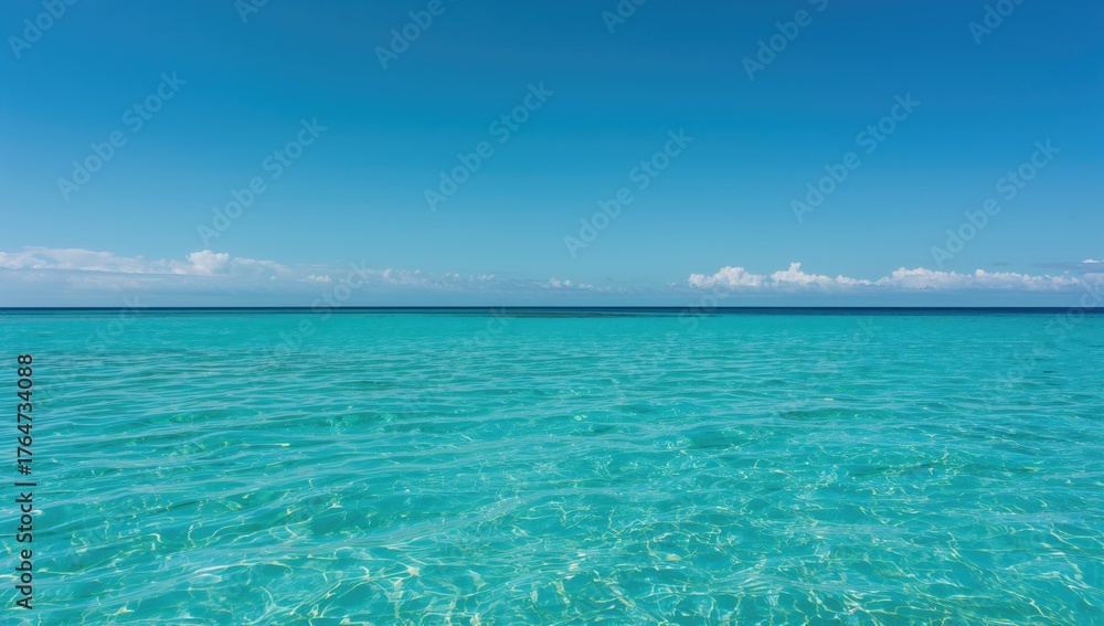 Obraz premium Clear turquoise coastal inlet with sparkling water under a bright sky, perfect for serene relaxation.