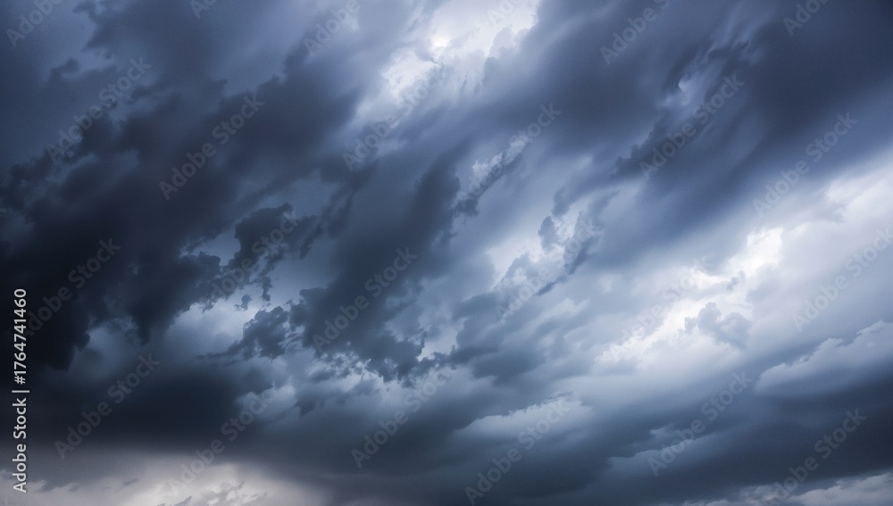 Obraz premium The menacing clouds formed a powerful and eerie atmosphere, producing a shadowy and surreal backdrop as the air brimmed with the feeling of an approaching catastrophe during the stormy season