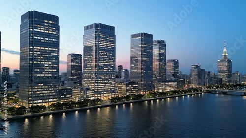 Wallpaper Mural A dusk cityscape with illuminated high-rises by water, reflecting lights, and bridges Torontodigital.ca