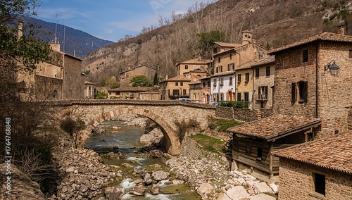 Ancient stone bridge spanning a mountain river in a quaint rural village