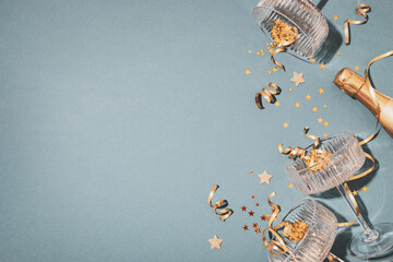 Party fashion background with champagne glasses and bottle and golden confetti stars. Christmas, birthday or wedding concept. Flat lay style.