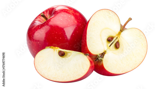 Glossy red apple, with slices exposing core and seeds, set against a stark black background