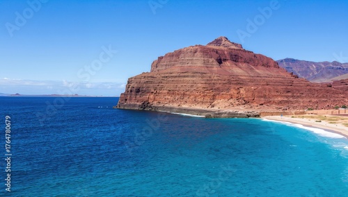 Wallpaper Mural Crimson rock formation amidst the azure ocean Torontodigital.ca