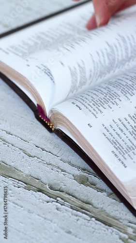 Turning pages and reading from open holy bible book. Vertical video. Christian Scripture study, biblical concept.