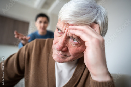 Fotografija Close up exhausted senior husband silently bearing relentless verbal assault from shouting wife