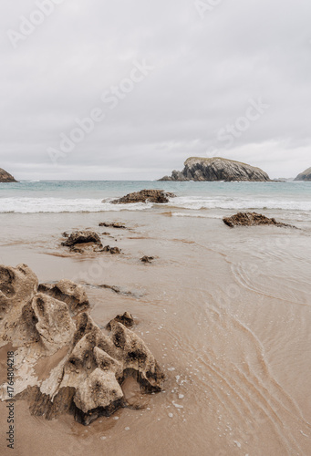 Moody and rocky beach landscape, neutral and desaturated aesthetic palette, with copy space