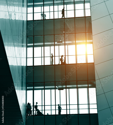 silhouettes of business people rushing at morden office building.