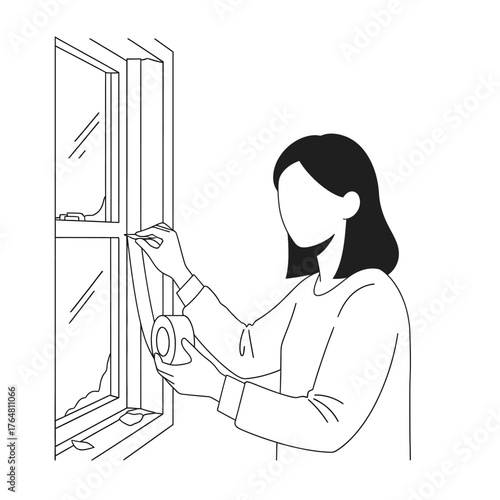 Woman applying tape to window frame to seal it, illustrating home insulation and energy saving measures