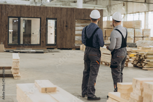 Photos Construction workers inspecting modular building in factory