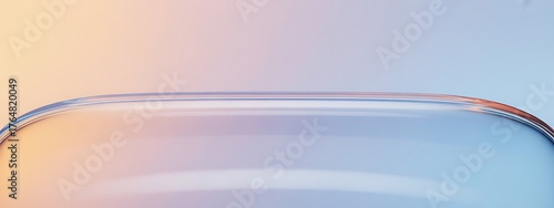 Abstract close up of curved glass with soft pastel gradient background