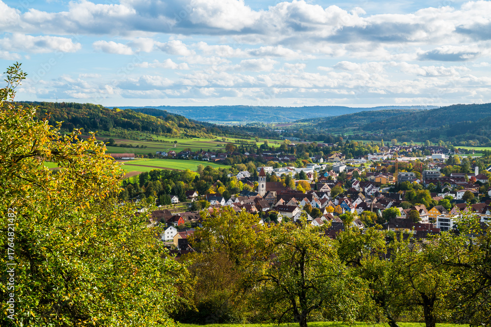 Obraz premium Germany, Rudersberg city panorama view above houses, roofs, green nature landscape on sunny day in rems murr kreis in autumn season