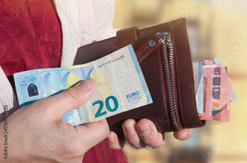 Fotografija Leather wallet and euro banknotes in a woman's hands, selective focus