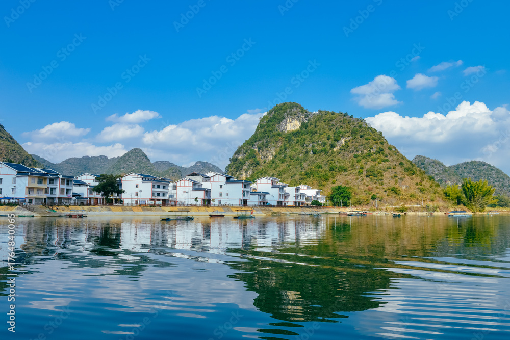 Fototapeta premium Quyang Lake (Quyanghu) karst peaks landscape reflection in water in Baise city, Guangxi province, China