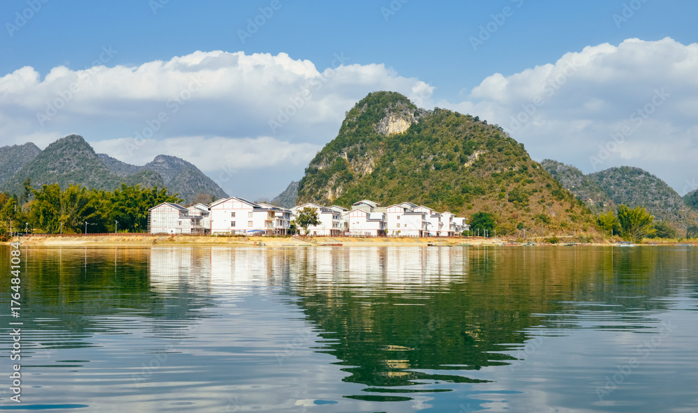 Fototapeta premium Quyang Lake (Quyanghu) karst peaks landscape reflection in water in Baise city, Guangxi province, China