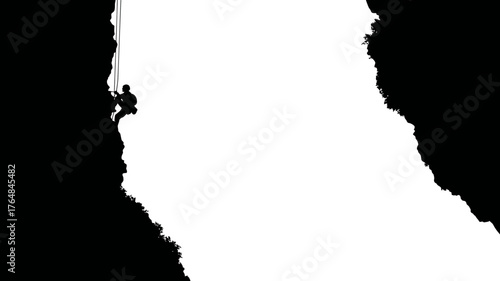 Dynamic silhouette of a male climber rappelling down a rugged rock face. Adventure, extreme sports, challenge, and determination concept.