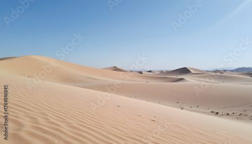 Vast Desert Landscape with Rolling Sand Dunes and Clear Blue Sky Under Bright Sunlight