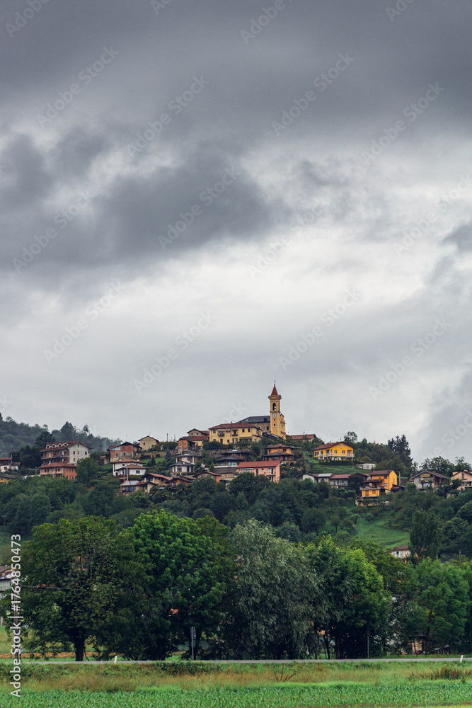 Fototapeta premium Picturesque hillside village under cloudy sky