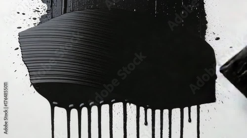 Black paint dripping from brush stroke on white background