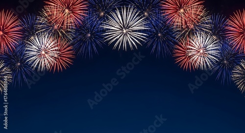 Vibrant red white and blue fireworks bursting in a dark night sky
