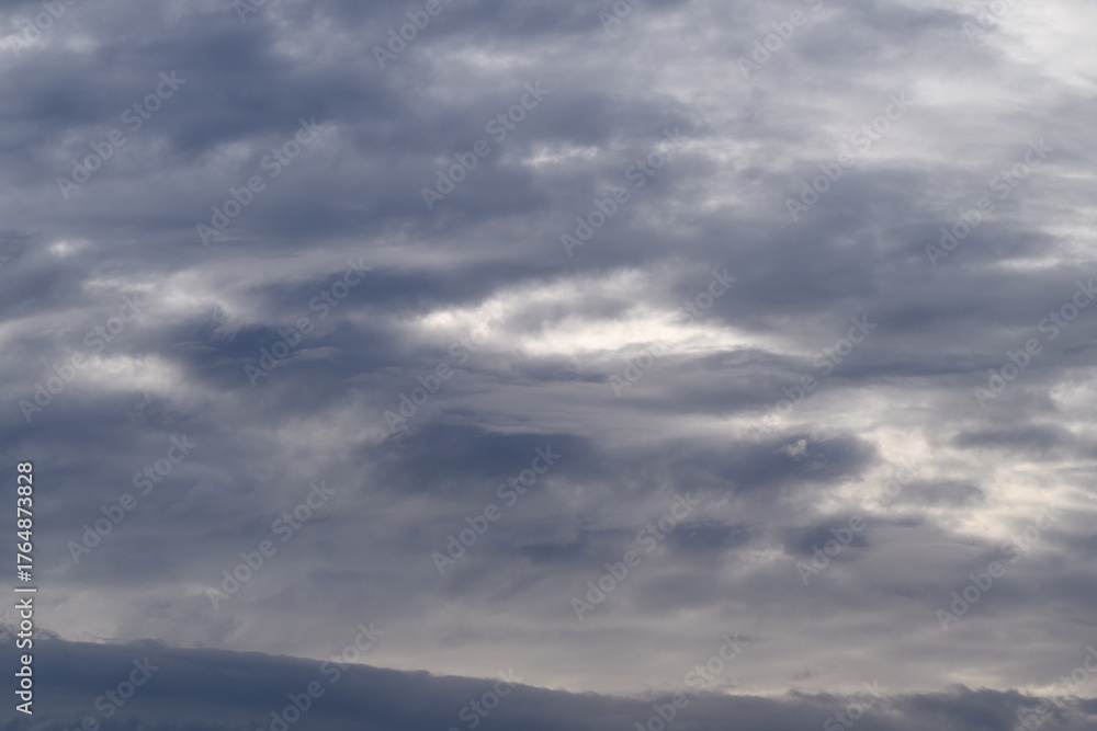 Obraz premium A Dramatic Overcast Sky Displaying Various Shades of Gray Clouds Above the Landscape