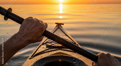 Person kayaking on a calm lake at sunset. First-person view of hands holding a paddle with a golden sun reflection on the water. Outdoor adventure and recreation concept