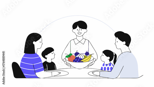 A family sitting around a dinner table with a healthcare worker illustrating healthy eating habits by displaying a colorful variety of fruits and vegetables.