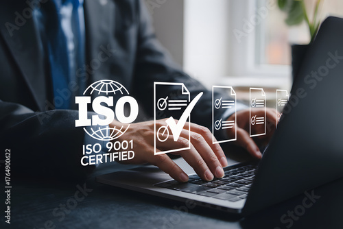 business quality control audit with iso 9001 standard documents on computer
