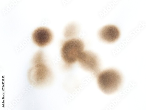 Burned paper with black scorch stains and aged texture. Paper burned with black marks. Old stained paper showing fire damage and discoloration.