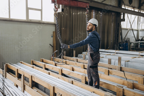 Wallpaper Mural Factory worker handling aluminum profiles for windows and doors production Torontodigital.ca