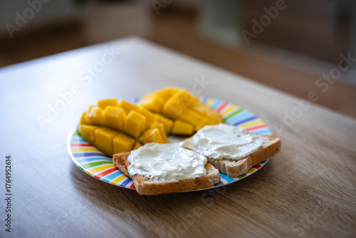 Deliciously fresh mango slices with creamy toast make a vibrant and healthy breakfast treat perfect for morning light