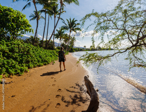 Female Tourist Walking Under Coconut Palm Trees on One Alii Beach, One Alii Beach Park, Molokai, Hawaii, USA