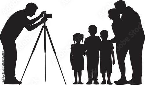 Silhouette of a photographer taking a picture of a family with two children camera tripod
