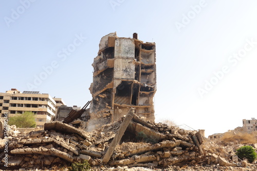 Bild auf Leinwand War damaged building in Aleppo, Syria, showing destruction from heavy battles