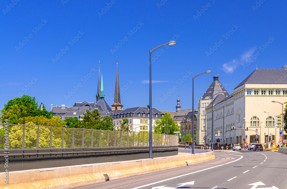 Fototapeta premium Road leading to Ville Haute quarter with Palace of Justice buildings of Judiciary City Cite judiciaire and churches spires in Luxembourg City historical centre