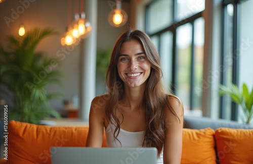 Young woman smiles working on laptop computer at home couch. Happy female using tech for online business or study. Relaxed person with notebook enjoys digital life in cozy indoor space. Free Download Young woman smiles working on laptop computer at home couch. Happy female using tech for online business or study. Relaxed person with notebook enjoys digital life in cozy indoor space. - GFXLoad