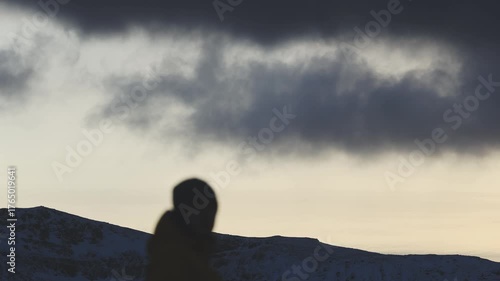 Man stands on the final rock above wild Arctic scenery in Northern Norway, alone with his thoughts