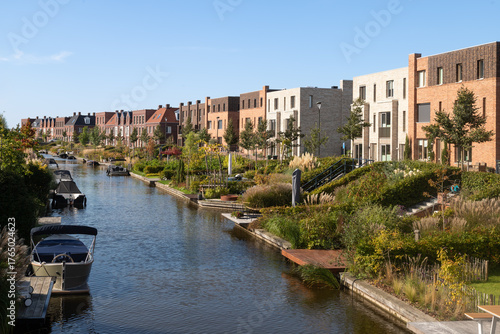 Modern residential buildings with gardens along the canal in the Vathorst district of Amersfoort.