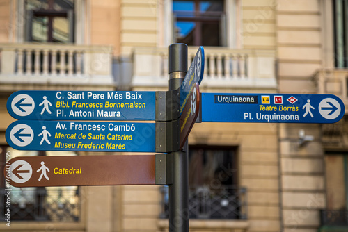 Street signs marking the direction to the few famous sites to visit in Barcelona, Spain